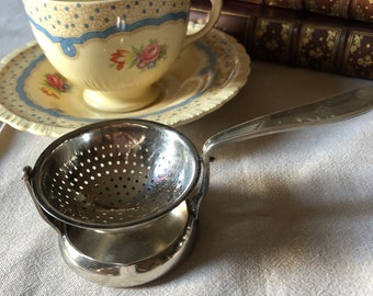 Passe-thé à bascule en métal argenté Christofle, modèle Vibrations