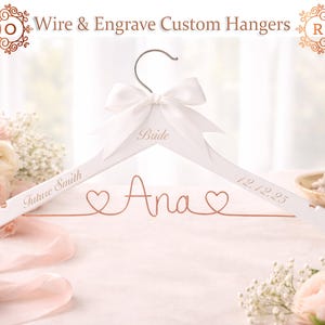 May include: A white wooden hanger with a silver hook and a white satin bow. The hanger is engraved with the word "Bride", the name "Ana", the date "12.12.25", and the words "Future Smith".