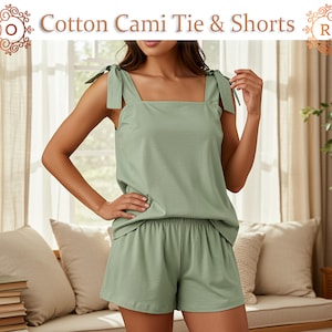 May include: A light green cotton cami top and shorts set. The cami top has tie straps and a square neckline. The shorts are a matching light green color. The text "Cotton Cami Tie & Shorts" is displayed at the top of the image.
