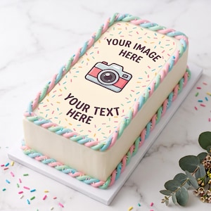 May include: A rectangular sheet cake with smooth white frosting, decorated with a pastel pink and blue twisted rope border. The top features colorful sprinkles and a central graphic of a camera with the text YOUR IMAGE HERE and YOUR TEXT HERE.