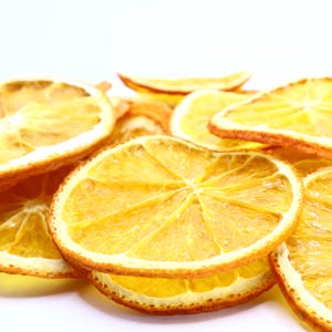 Collection of artisan dried orange slices crafted for use as cocktail garnish, dessert topper, or natural dry fruit snack. These dried citrus slices have been evenly dried to approx. 3 mm for consistent texture. Made from the best dry oranges, they offer authentic citrus flavor and appealing visual style. Vegan and vegetarian friendly, perfect for food, drinks, and décor.