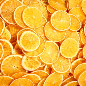 Aesthetic display of multiple dried orange slices on a neutral background. Great for eco-friendly home styling, dried fruit crafts, or citrus cocktail garnish ideas.