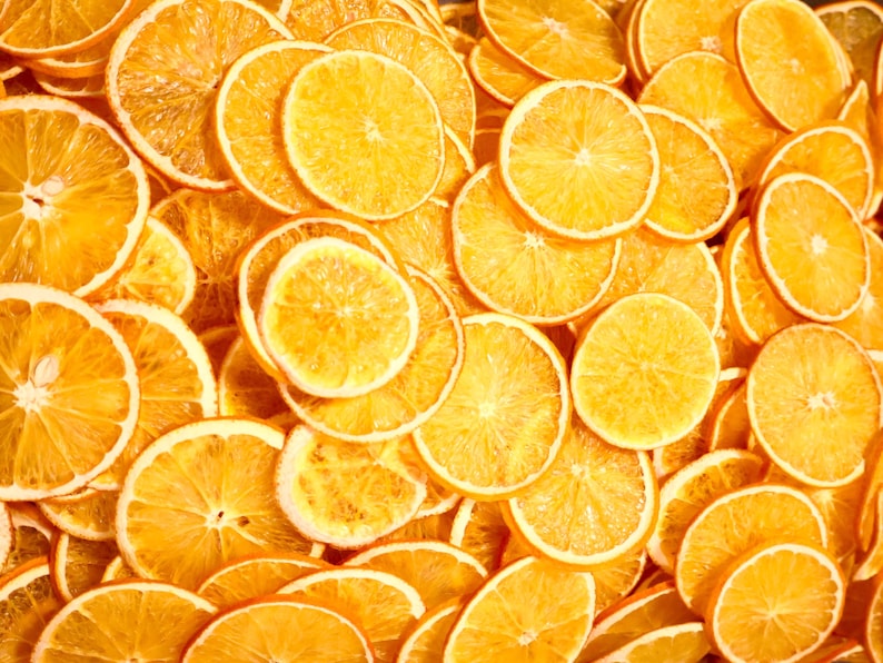 Aesthetic display of multiple dried orange slices on a neutral background. Great for eco-friendly home styling, dried fruit crafts, or citrus cocktail garnish ideas.