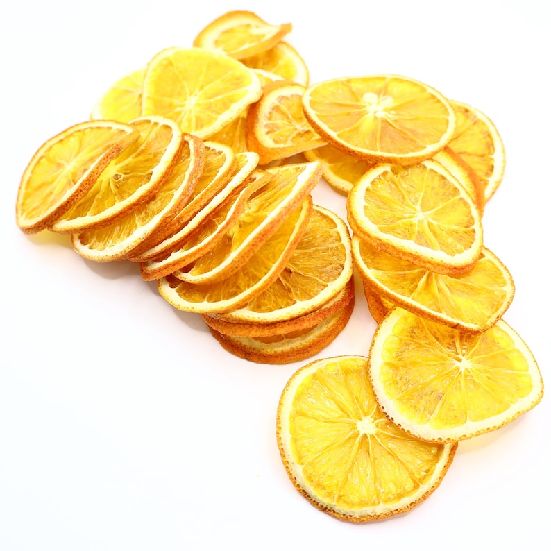 Stylish display of orange dried slices, a natural and versatile choice for cocktail garnish, tea, desserts, or DIY decorations. Produced using the best technology from premium dried natural fruits, ensuring freshness, vibrant orange tones, and delicious taste. These dried citrus slices are healthy dry fruit, vegan, vegetarian, and a must-have for eco-conscious food lovers.