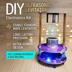 May include: A DIY ultrasonic levitator electronics kit. The kit features a purple base with a silver cylinder and gold support rods. The text on the image reads "STABLE STANDING WAVE LEVITATION", "LONG-LASTING PRECISION", and "ULTRA-COMPACT DESIGN".