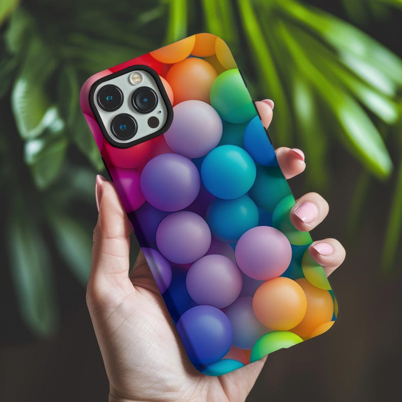 May include: A colorful phone case with a pattern of overlapping spheres in shades of blue, purple, green, orange, and red.