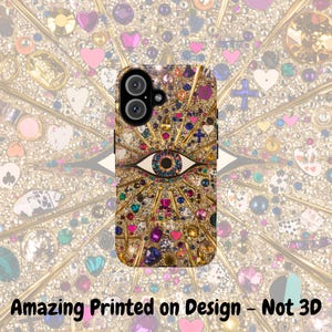 May include: A gold, black, and multi-colored phone case with a large eye design and glitter accents. The case is designed for a phone with a dual camera lens.