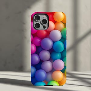 May include: A colorful phone case with a pattern of rainbow-colored balls. The case is designed for an iPhone.