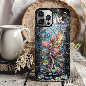 May include: A phone case with a mosaic design featuring a fairy with wings and a flower. The fairy is surrounded by flowers and leaves. The case is black with a clear back.