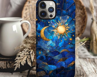 May include: A blue and gold phone case with a stained glass design of a sun, moon, and stars. The case is made for an iPhone with a camera bump.