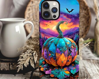 May include: A colorful phone case featuring a vibrant pumpkin design. The pumpkin is adorned with blue, orange, and purple leaves, set against a sunset sky with a bat silhouette. The case has a glossy finish.