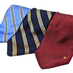 May include: Three neckties in different patterns and colors. One is blue with white stripes, another is navy blue with yellow stripes, and the last is solid burgundy.