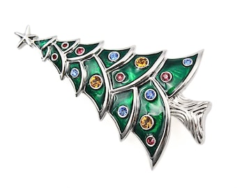 May include: A Christmas tree brooch with a green enamel finish and silver-tone metal trim. The brooch is decorated with red, blue, and yellow rhinestones. A star tops the tree design.
