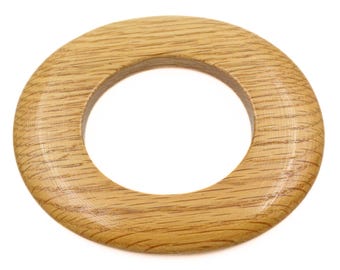 May include: A circular wooden ring with a light brown finish. The ring has a smooth, polished surface and a circular opening in the centre. The wood grain is visible, adding texture. Suitable for crafts and home decor, this item is made of wood.