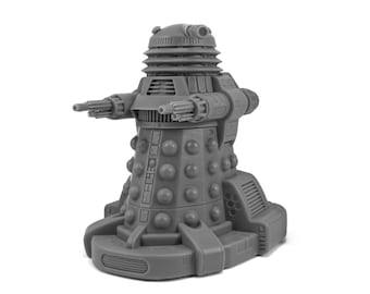 May include: A gray, stylized Dalek figurine, a fictional extraterrestrial race from the British science fiction television program Doctor Who. The figurine has a cylindrical body with a series of round bumps and two arm-like appendages.