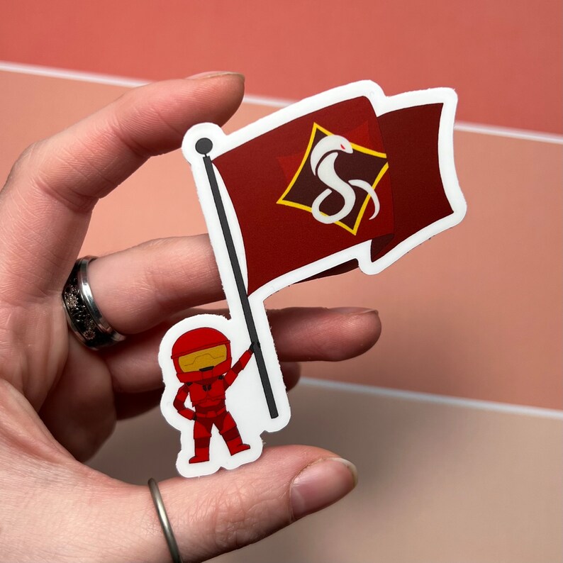 May include: A red and white sticker featuring a cartoon character holding a flag with a white snake logo on a red background. The logo is inside a yellow diamond shape.
