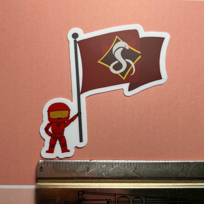 May include: A red and white sticker featuring a cartoon character holding a flag with a white snake logo on a maroon background. The flag has a white border and the snake logo is inside a diamond shape.