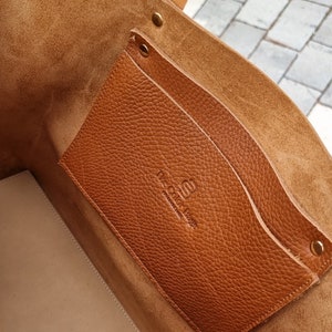 inside the leather bag, you can see a pocket