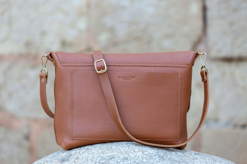 back of the leather crossbody bag, it is shown to have a very practical pocket.