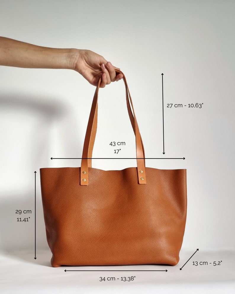 bag dimensions are shown:
Height: 11.41" / 29 cm
Width at top 17" / 43 cm (stretched)
Width at bottom 13.38" / 34 cm (stretched)
Depth: 5.12"/13 cm
Strap drop: 10.63"/27 cm
