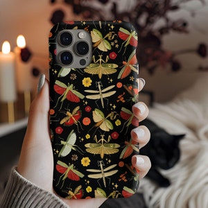 May include: A black phone case with a colorful pattern of insects, including mantises, butterflies, and dragonflies. The case has a camera cutout and a black background.