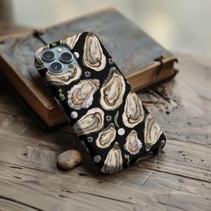 May include: Black phone case with a watercolor design of oysters and pearls.