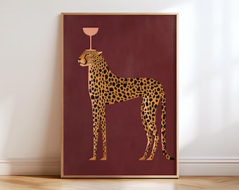 May include: A rectangular wall art print featuring a standing leopard with a spotted yellow and black coat against a solid deep maroon background. A pale pink stemmed cocktail glass is balanced on the leopard's head.