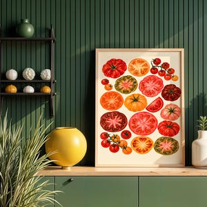 May include: A framed wall art print featuring a collection of various tomatoes in shades of red, orange, yellow, and green. The illustration displays whole tomatoes, sliced cross-sections, and small clusters on the vine against a cream background.
