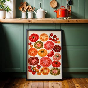May include: A framed rectangular wall art print featuring a collection of various heirloom tomatoes in shades of red, orange, yellow, green, and purple. The illustration displays both whole tomatoes and cross-section slices arranged on a cream background.