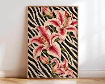 May include: A rectangular framed wall art print featuring a vibrant illustration of pink and white spotted lily flowers with green leaves set against a bold black and white zebra stripe pattern background. The frame is a light-toned natural wood finish.