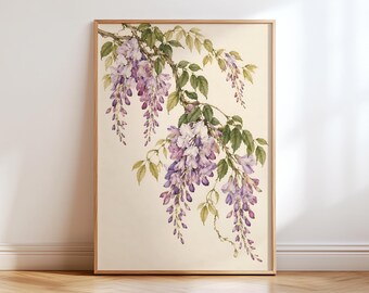May include: A framed botanical print featuring a watercolor illustration of wisteria flowers in shades of purple and white, accompanied by green leaves and brown stems, set against a light cream-colored background within a wooden frame.