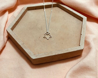 Star pendant on diamond cut curb chain