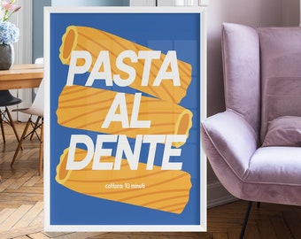 May include: A white framed poster with a blue background and the text "PASTA AL DENTE" in white letters. The text is surrounded by yellow pasta shapes. The poster is hanging on a wall in a room with a pink armchair.