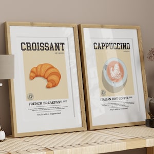 May include: Two framed prints with illustrations of a croissant and a cappuccino. The croissant print has the text "Croissant" and "French Breakfast 1977". The cappuccino print has the text "Cappuccino" and "Italian Hot Coffee 1908".
