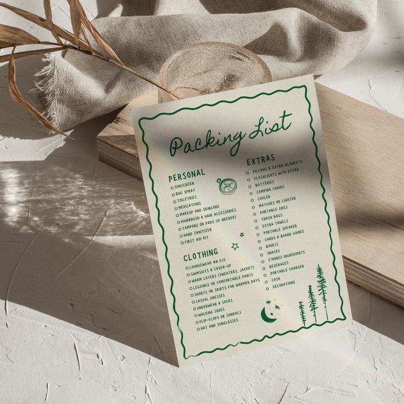 May include: A green and white printable packing list for camping trips. The list includes categories for personal items, clothing, and extras. The list is decorated with a compass, stars, and a crescent moon.