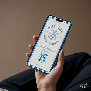 May include: A smartphone displays a digital invitation with a blue and white design. The text reads "Buy the Bride a Drink" with a seashell graphic. Additional text includes "Julianna's Bachelorette Weekend" and a QR code.