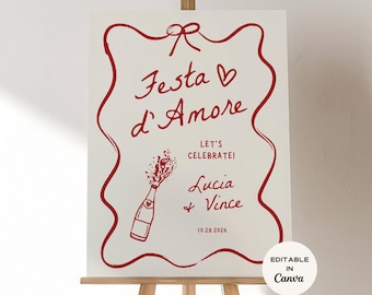 May include: A white sign with red lettering and a decorative border. The text reads "Festa d'Amore", "Let's Celebrate!", and names "Lucia + Vince" with a date. A champagne bottle illustration is also included.