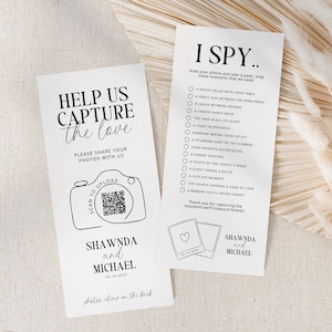 May include: A white card with black text that says "Help Us Capture the Love" and has a QR code and a camera illustration. The card also says "Please share your photos with us" and "Shawnda and Michael 10.15.202X". A second white card with black text says "I Spy... Grab your phone and take a peek, snap these moments that we seek!" and has a list of things to photograph at a wedding. The card also says "Shawnda and Michael".