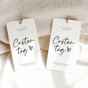 May include: Two white gift tags with black text that reads "FULLY EDITABLE TEMPLATE" and "Custom tag" with a heart symbol. The text "CREATE AND PRINT AS MANY TAGS AS YOU NEED!" is also included on each tag.