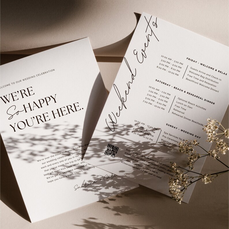May include: A wedding invitation with a white background and black text. The invitation includes a welcome message, a weekend schedule of events, and a QR code. The text reads "We're so happy you're here." and "Weekend Events".