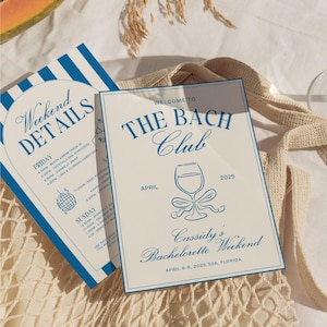 May include: A white card with blue text and a blue wine glass illustration. The text reads "Welcome to The Bach Club" and "Cassidy's Bachelorette Weekend April 6-8, 2025 30A, Florida".
