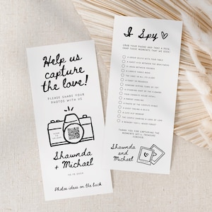 May include: A white card with black text that says "Help us capture the love!" and features a cartoon camera with a QR code. The card also says "Please share your photos with us" and has the names "Shawnda + Michael" and the date "10.15.202x". The back of the card has photo ideas.