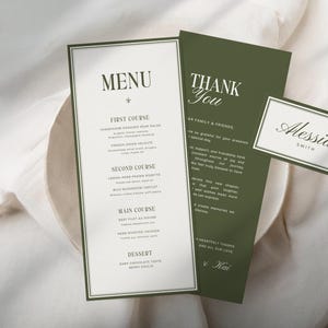 May include: Elegant wedding stationery set featuring a menu, thank you card, and place card. The menu lists courses like Champagne Peaches Pear Salad. The cards are white with dark green borders and text. The place card reads "Alessia Smith."