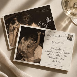 May include: Two rectangular save the date cards featuring sepia-toned photographs of a couple. The cards include the text Margot & Julian, Save the Date, Destination: San Sebastian, Spain, September 29, 2029, and a printed floral postage stamp design.