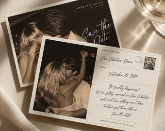 May include: Two rectangular save the date cards featuring sepia-toned photographs of a couple. The cards include the text Margot & Julian, Save the Date, Destination: San Sebastian, Spain, September 29, 2029, and a printed floral postage stamp design.