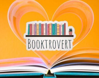 May include: A sticker with the word "BOOKTROVERT" and a shelf of colorful books, set against an orange heart shape and an open book. The sticker includes a small potted plant. The background is a vibrant orange.