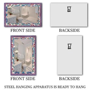 May include: Rectangular mirror with a decorative floral border in shades of blue, red, and white. The mirror reflects a bathroom scene. The backside of the mirror is plain white with a steel hanging apparatus.