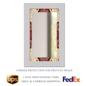 May include: Rectangular mirror with a white frame and a decorative border featuring a maroon and gold paisley pattern. The mirror's surface reflects a blurred outdoor scene. The text "CORNER PROTECTION FOR PREVENT IMAGE" is visible at the bottom.