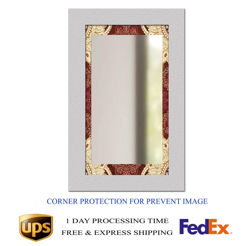 May include: Rectangular mirror with a white frame and a decorative border featuring a maroon and gold paisley pattern. The mirror's surface reflects a blurred outdoor scene. The text "CORNER PROTECTION FOR PREVENT IMAGE" is visible at the bottom.