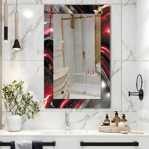 May include: A rectangular bathroom mirror with a decorative frame featuring red, black, gold, and silver swirls. The mirror reflects a bathroom with a shower, sink, and marble tile.
